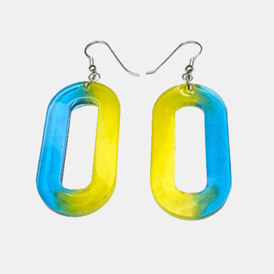 Grote handgemaakte ovale epoxy oorbellen met een artistiek kleurverloop van helderblauw naar levendig geel en zilverkleurige haakjes.