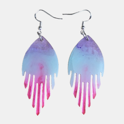 Close-up van een vrouw die een handgemaakte abstracte epoxy oorbel draagt met een paars naar roze kleurverloop